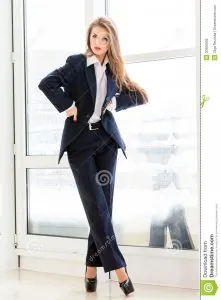 young-business-woman-wearing-man-s-suit-high-heels-office-looking-bossy-30966936.jpg
