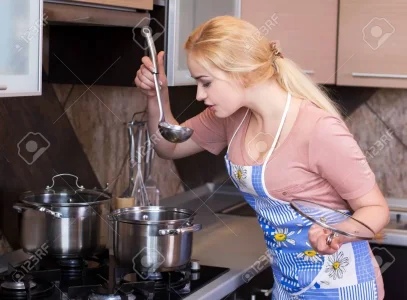 23514124-femme-cuisine-belle-femme-souriante-heureux-à-l-intérieur-de-la-cuisine-de-cuisson-en...jpg